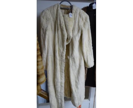 A white fur coat and matching stole.