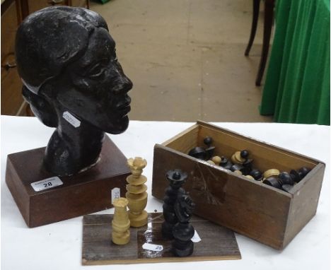 Turned wood chess set and a metal sculpture of a female head on plinth.