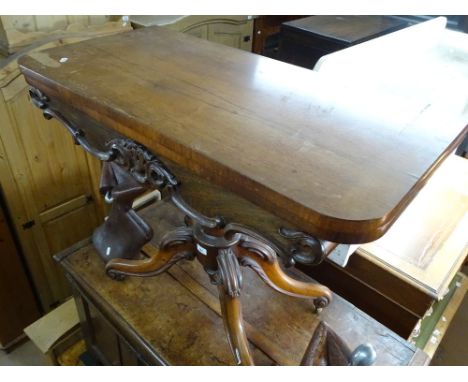 A William IV rosewood rectangular foldover card table, with carved frieze raised on turned centre column and sabre leg, width