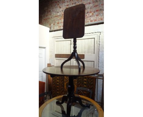 A Georgian mahogany circular tilt top tripod table, together with a similar tilt top table, (2).