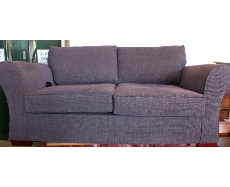 A purple upholstered sofa bed