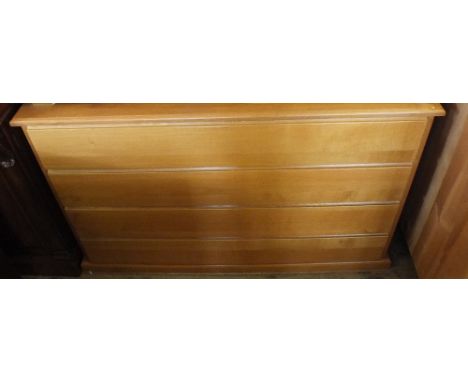 A modern light Oak chest of four long drawers