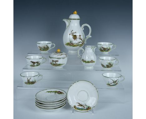 This lovely grouping comprises a teapot, a covered sugar, a creamer, and six cups with saucers. Each piece features hand-pain