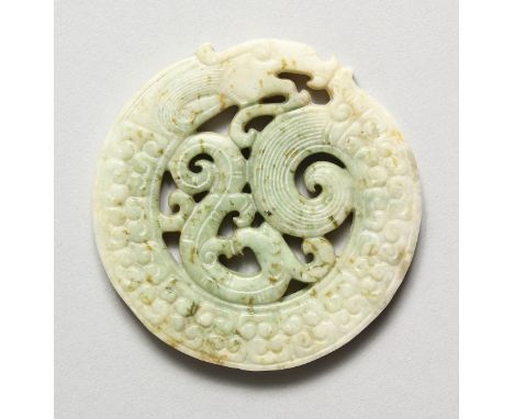 A CHINESE PIERCED JADE ROUNDEL, 2.75 ins diameter.