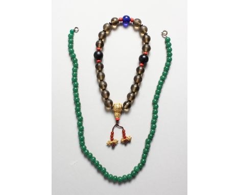 ASIAN PRAYER BEADS WITH GILT CHARM and a jade necklace, 20 inches long.