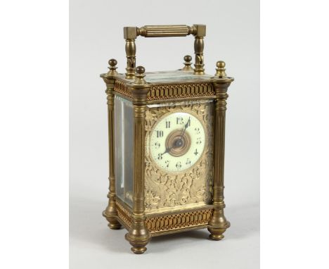 A 19TH CENTURY FRENCH BRASS CARRIAGE CLOCK  with filigree face and coloured sides 61/2 ins.