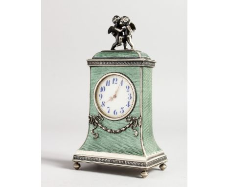 A SUPERB RUSSIAN SILVER AND ENAMEL CLOCK, the top with two cupids, stamped 88, ER and Faberge mark. 6 ins long