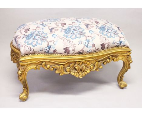 A GILT WOOD LARGE STOOL, upholstered with a floral print fabric on cabriole legs 3 ft 10 ins long x 2 ft 5 ins wide x 2 ft hi
