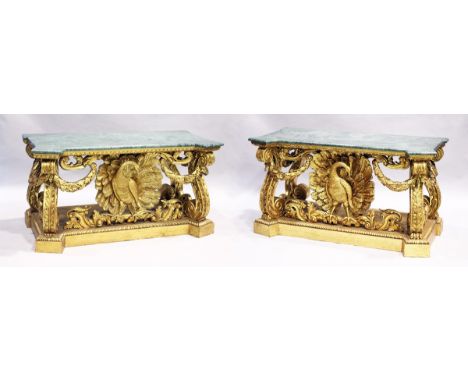 A SUPERB PAIR OF EARLY GEORGIAN, WILLIALM KENT DESIGN, MARBLE TOP AND GILDED CONSOLE TABLES.  The bases carved with peacocks,