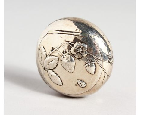 A HAMMERED CIRCULAR SILVER SNUFF BOX repousse with leaves and flowers