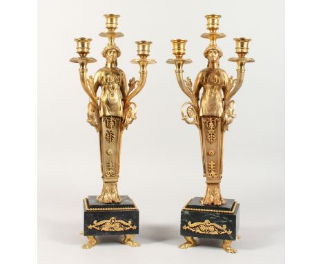 A GOOD PAIR OF EMPIRE DESIGN CLASSICAL  THREE LIGHT CANDLESTICKS on  marble bases. 18 ins high.