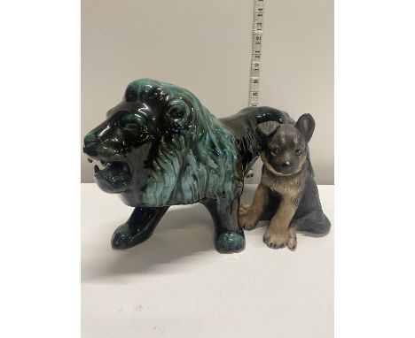 A large ceramic lion figurine and a Lennox porcelain German Sheppard puppy figure, shipping unavailable
