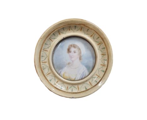 A Georgian painted miniature portrait of a young lady in a round frame to reverse 'Lady Armitage' overall diameter 11cm
