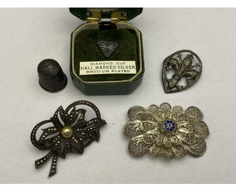 A selection of vintage silver and white metals brooches etc