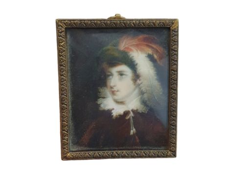 A Georgian painted miniature portrait in a brass frame of a young lady with feathers in her hair, overall dimensions 8x6.5cm