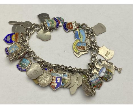 A white metal chain with a large selection of silver charms