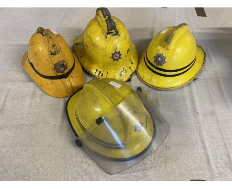 Four vintage fireman's helmets, A/F, shipping unavailable