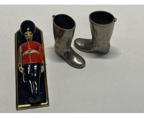 A novelty heavy brass door knocker and pair of novelty metal boots