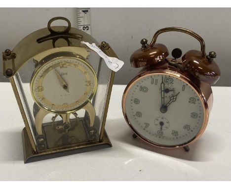 A vintage brass Schatz clock with a vintage alarm clock (untested), shipping unavailable