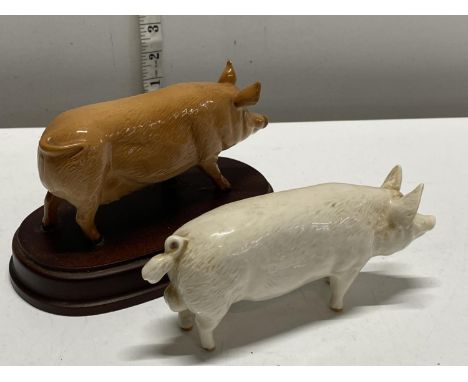 Two vintage Beswick pigs, one on wooden plinth