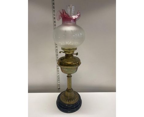 An antique brass based oil lamp with etched shade, shipping unavailable