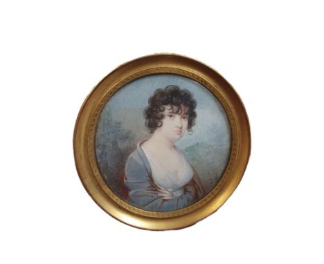 A Georgian painted portrait miniature in a round brass frame (signature illegible) overall diameter 7cm