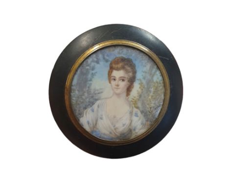 A Georgian miniature painted portrait of lady in ebonized frame (signature illegible) overall diameter 9cm