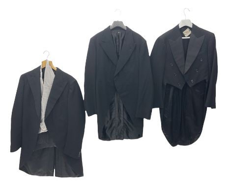 Two gentlemen's vintage black morning jackets, together with pair of suit trousers and waistcoat, and a black mess jacket wit