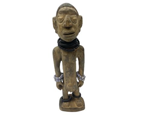 Early 20th century West African Yoruba family wooden figure of Orisha Oko, the god of farming/agriculture, carved from the so
