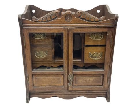 Oak smokers cabinet, twin glazed doors enclosing four small drawers and a pipe rack, H46cm
