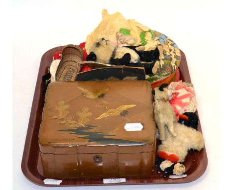 A small group of textiles including a 19th century sampler (unframed), an articulated stuffed panda possibly Steiff, stuffed 