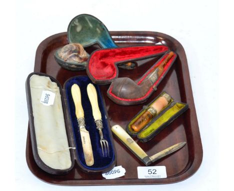 A cased meerschaum pipe, silver collared pipe, silver mounted cheroot holder all with amber mouth pieces together with a case