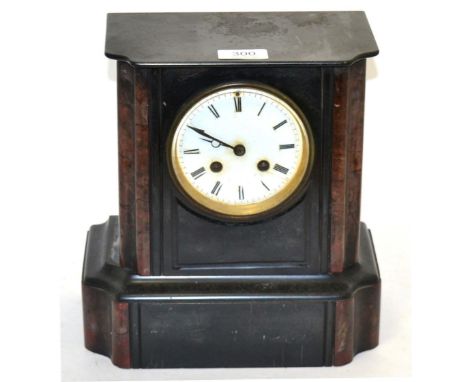 A black slate and marble striking mantel clock
