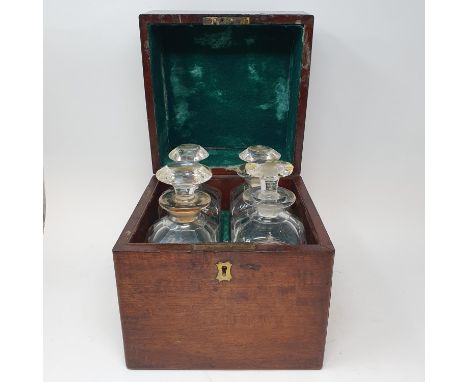 A 19th century mahogany and brass bound decanter box, with a hinge lid to reveal four cut glass decanters, 23 cm wide 