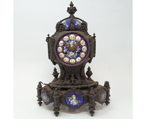 A late 19th century Continental mantel clock, the 8.5 cm diameter enamel dial with Roman numerals and decorated armour and fl