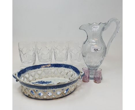 A 19th century cut glass jug, 26 cm high, a set of four Waterford cut glass tumblers, a blue and white pierced glass basket, 