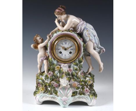 A late 19th century mantel clock, the 8 cm diameter enamel dial with Roman numerals, fitted an eight day movement, in a porce
