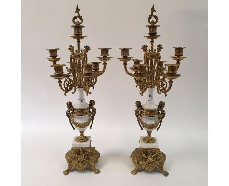 A pair of Victorian style gilt metal seven light candelabra, from a clock garniture, 68 cm high (2) 