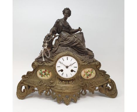 A late Victorian mantel clock, the 8 cm diameter enamel dial with Roman numerals, in a spelter figural case, 35 cm high 