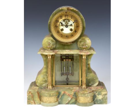 A late Victorian mantel clock, the 10 cm diameter brass chapter ring with Arabic numerals, with exposed escapement to the cen