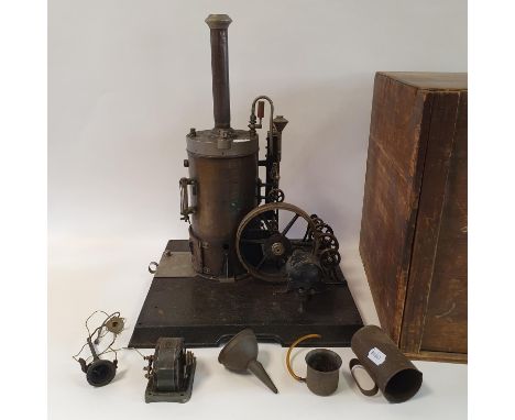 An early/mid 20th century vertical steam engine, on a plinth base, with attached pulleys, 50 cm high, in a travelling wooden 