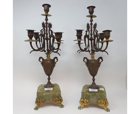 A pair of spelter and onyx five light candelabra, from a clock garniture, 46.5 cm high (2) 