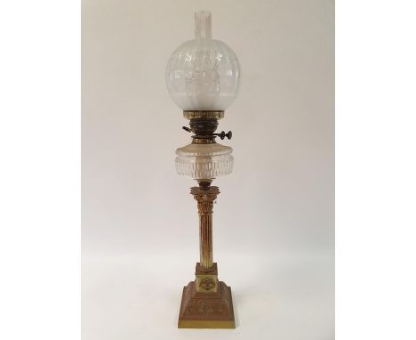 An oil lamp, with an acid etched glass shade, a clear glass well on a brass base in the form of a Corinthian column, 80 cm hi