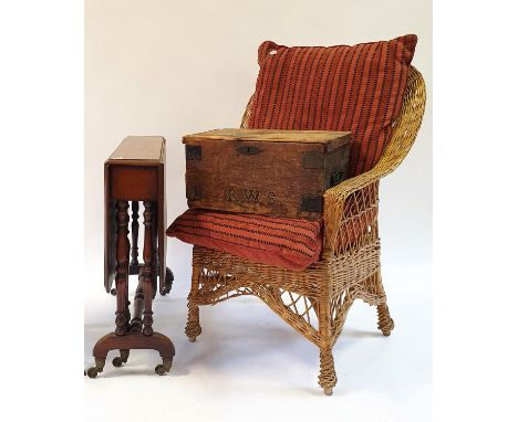 A mahogany Sutherland table, a pine box, a wicker armchair, a Persian red ground carpet, a modern cream ground carpet, and a 