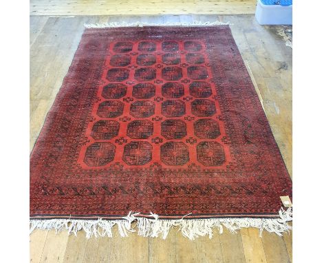 An Afghan red ground carpet, 272 x 188 cm 