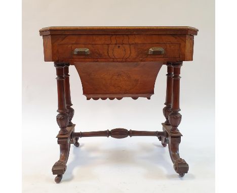 A Victorian walnut games table, with folding top, and slide to reveal chess and backgammon boards, above a long drawer and bo