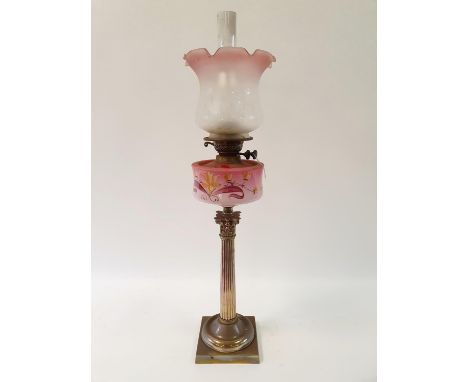 An oil lamp, with an acid etched glass shade, a pink glass well painted flowers, on a silver plated base in the form of a Cor