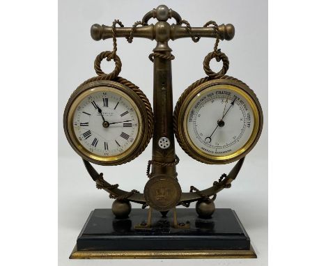 An early 20th century novelty desk set, incorporating a timepiece, a thermometer and an aneroid barometer, mounted on a ships