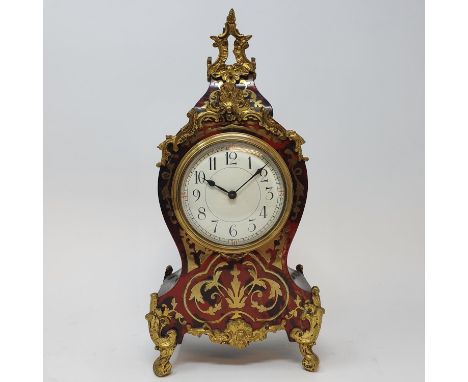 A Louis XVI style mantel clock, the 8.5 cm diameter dial with Arabic numerals, fitted an eight day movement in a Boulle mount