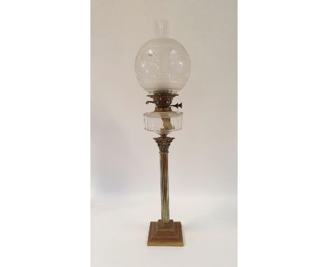 An oil lamp, with an acid etched glass shade and clear glass well on silver plated base in the form of a Corinthian column, 8